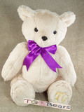 Theodore Bear with a purple ribbon