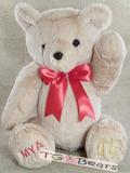 Handmade personalized teddy bear with a classic red bow